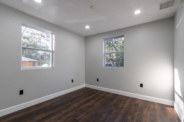 unfurnished room featuring dark wood-style floors, recessed lighting, visible vents, and baseboards