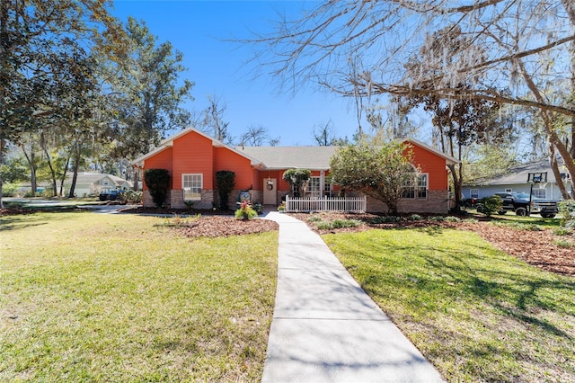 view of front of property with brick siding and a front lawn