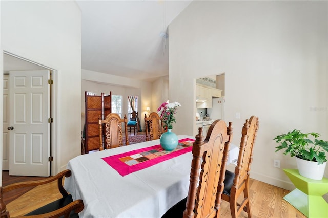 dining room featuring light wood-style floors and baseboards