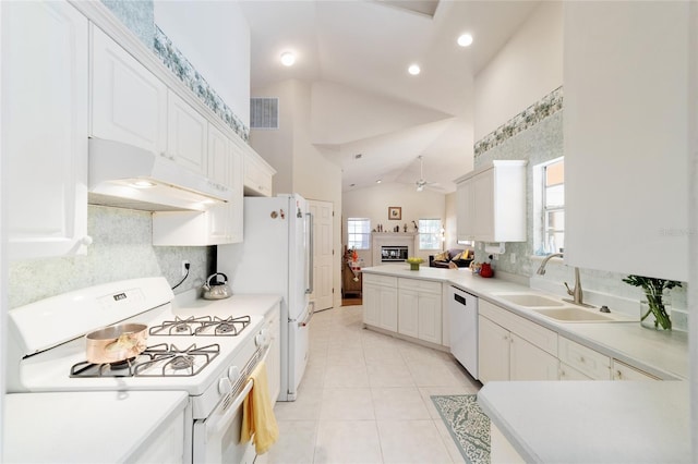 kitchen featuring light tile patterned floors, visible vents, a sink, white appliances, and under cabinet range hood