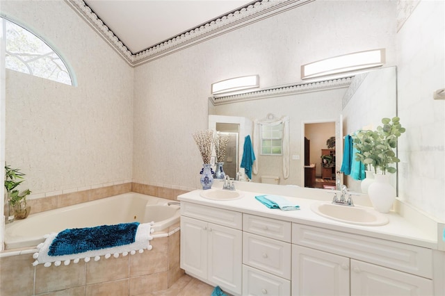 full bathroom featuring a garden tub, a sink, and double vanity