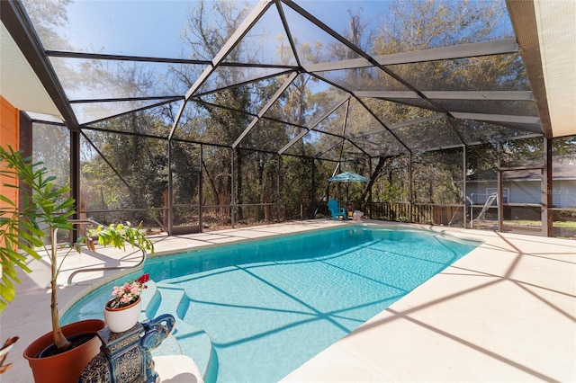 pool with glass enclosure and a patio