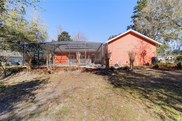 rear view of house featuring a patio and a lanai