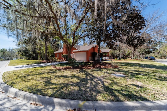 view of side of home featuring a garage and a yard