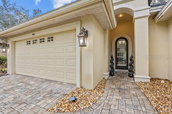 garage with decorative driveway