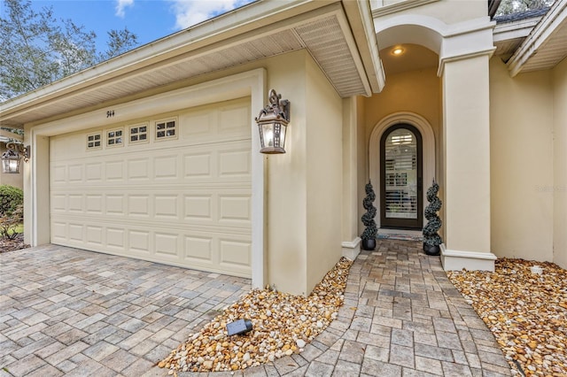 garage with decorative driveway