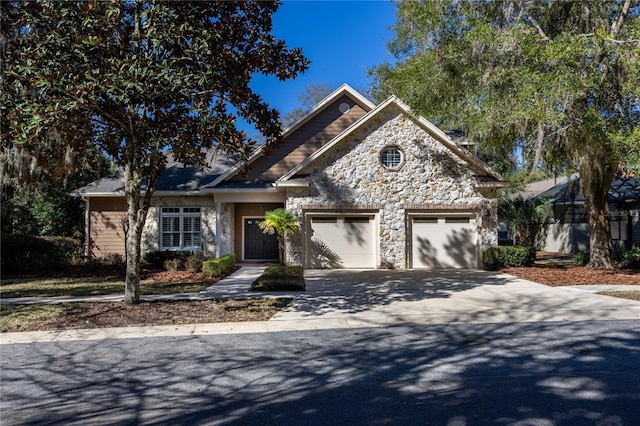 view of front of house with a garage, stone siding, and concrete driveway