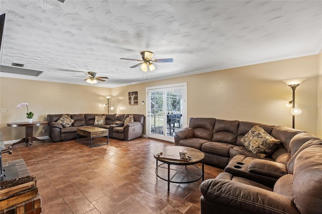 living room with a textured ceiling, ceiling fan, visible vents, baseboards, and crown molding