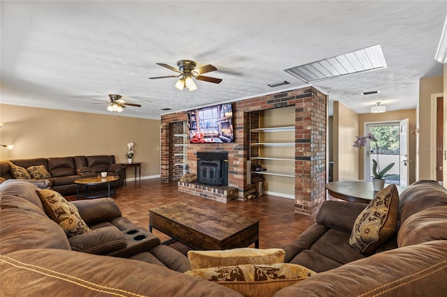 living area with baseboards, visible vents, built in features, ornamental molding, and a textured ceiling