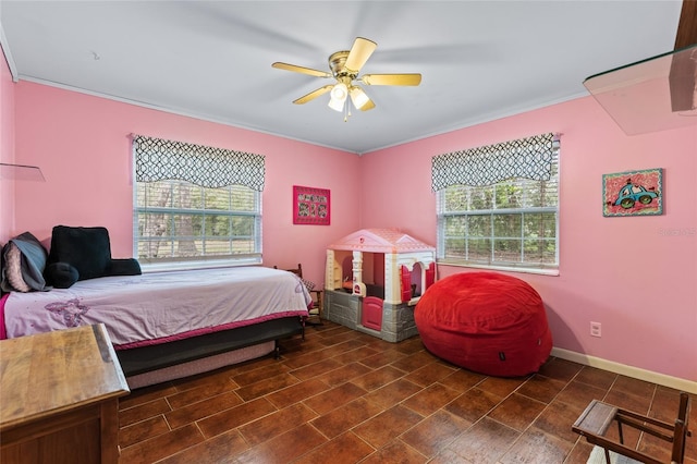 bedroom with ceiling fan, ornamental molding, multiple windows, and baseboards