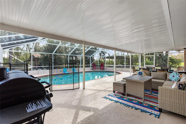 outdoor pool with glass enclosure, a patio, and an outdoor hangout area