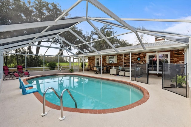 pool with glass enclosure, a patio area, and outdoor lounge area