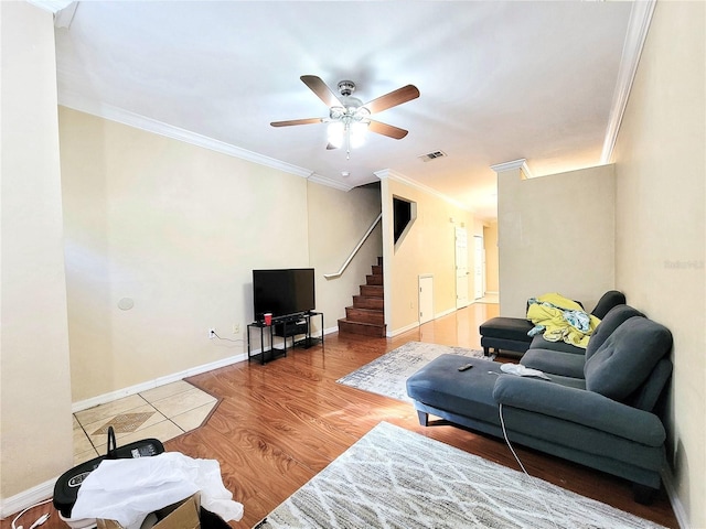 living area featuring ornamental molding, wood finished floors, visible vents, and baseboards