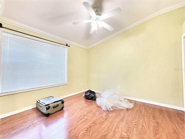 misc room featuring baseboards, crown molding, light wood finished floors, and ceiling fan