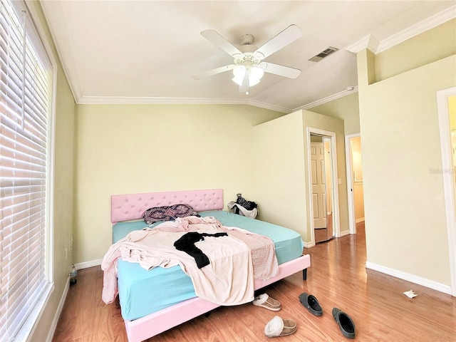 bedroom featuring crown molding, vaulted ceiling, baseboards, and wood finished floors