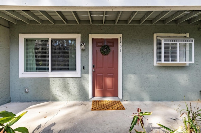 entrance to property with stucco siding