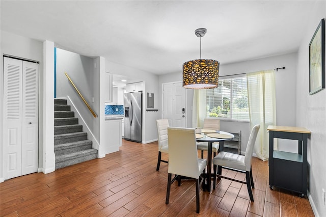 dining area with stairs, wood finished floors, and baseboards