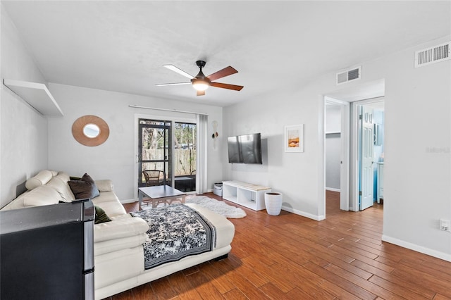 bedroom featuring baseboards, access to outside, visible vents, and wood finished floors