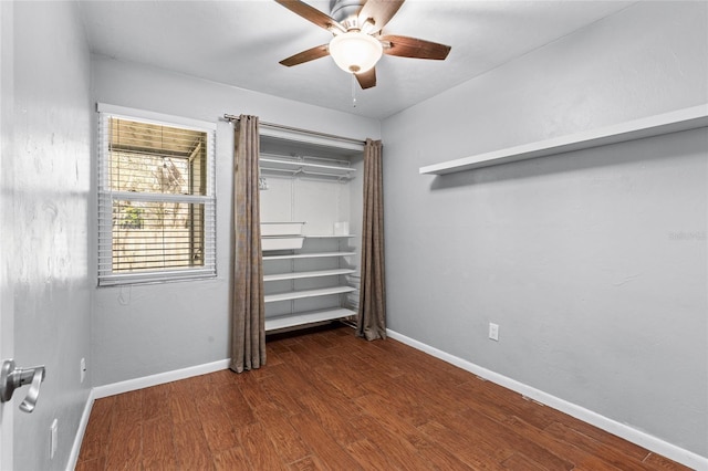 unfurnished bedroom featuring ceiling fan, baseboards, and wood finished floors