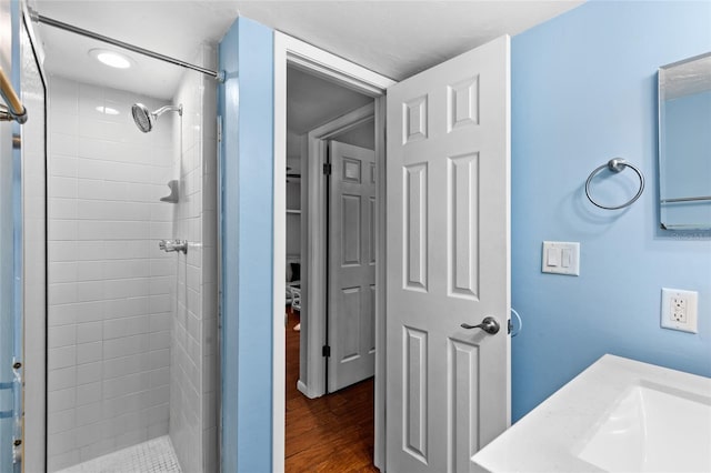 bathroom featuring a stall shower and wood finished floors