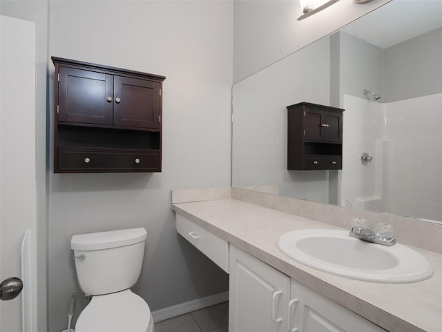 bathroom featuring baseboards, a shower, toilet, tile patterned flooring, and vanity