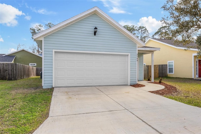 view of front of house with a garage, a front lawn, and fence