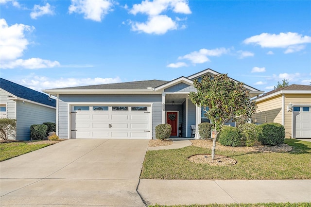 ranch-style home with driveway, a front lawn, and an attached garage