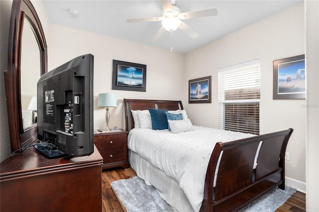 bedroom featuring ceiling fan, dark wood-type flooring, and baseboards