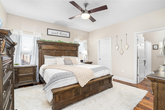 bedroom featuring wood finished floors, a ceiling fan, and baseboards