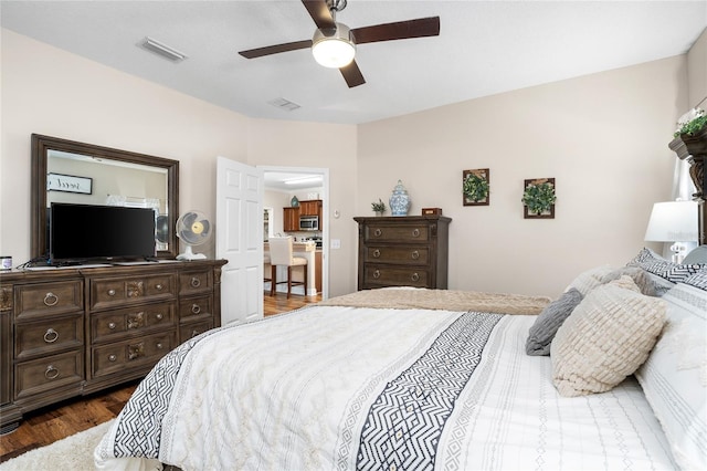 bedroom featuring ceiling fan, dark wood-style flooring, and visible vents