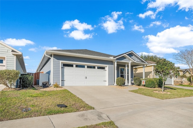 ranch-style house with driveway, an attached garage, and a front yard