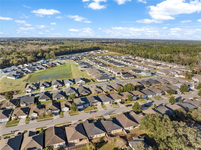 birds eye view of property featuring a residential view and a wooded view