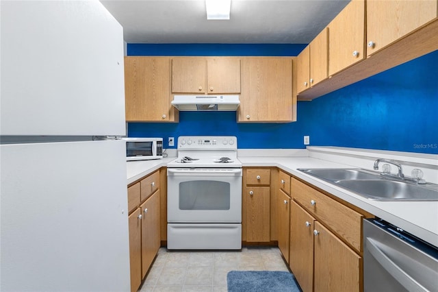 kitchen featuring white appliances, under cabinet range hood, light countertops, and a sink