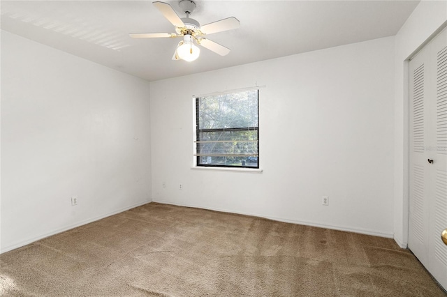 unfurnished bedroom with ceiling fan, a closet, and carpet flooring