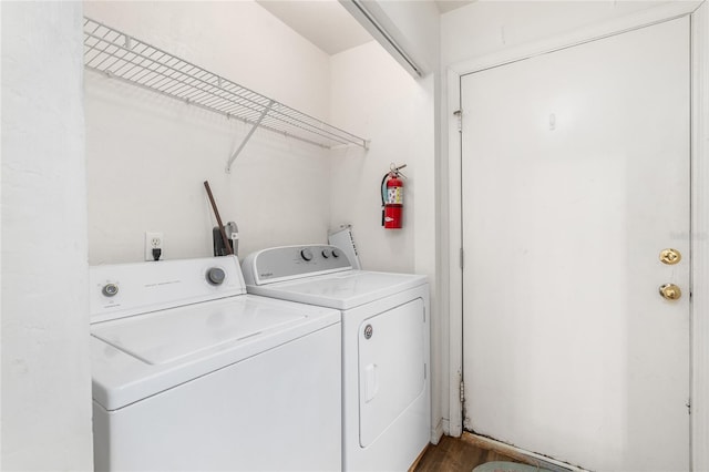 washroom with laundry area, wood finished floors, and washer and dryer