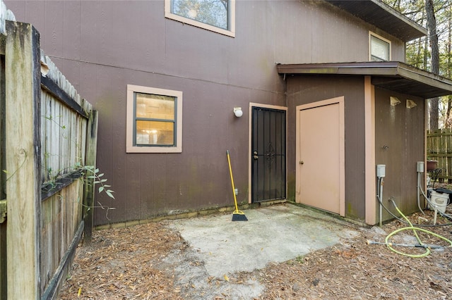 rear view of house featuring a patio area and fence