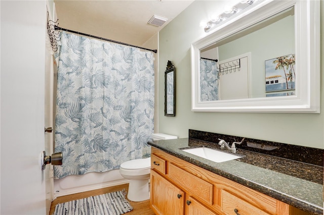 bathroom featuring toilet, shower / tub combo, visible vents, and vanity