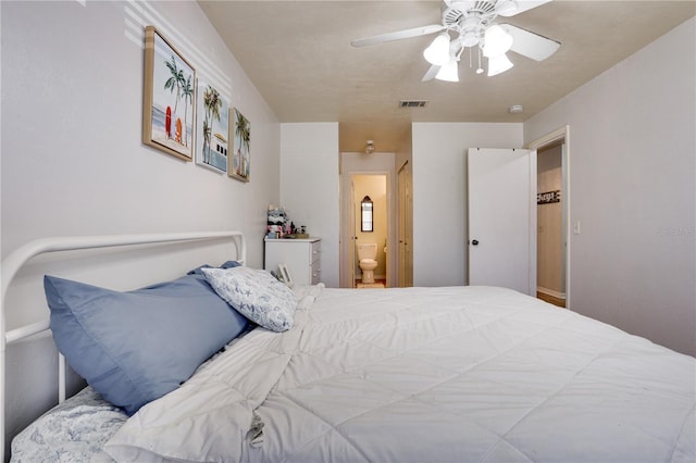 bedroom featuring ensuite bathroom, visible vents, and a ceiling fan