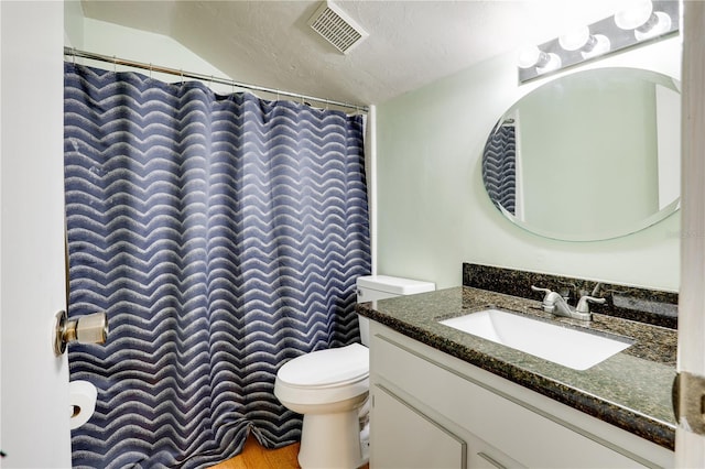 bathroom featuring toilet, visible vents, a textured ceiling, and vanity