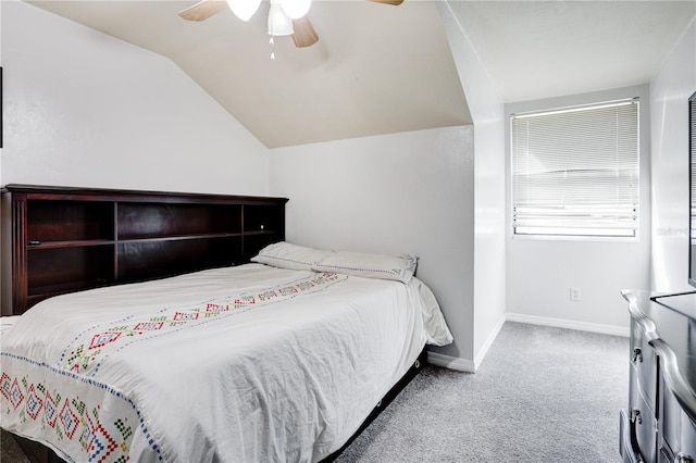 carpeted bedroom featuring vaulted ceiling, a ceiling fan, and baseboards