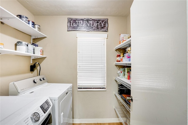 laundry room featuring baseboards, laundry area, and washer and dryer