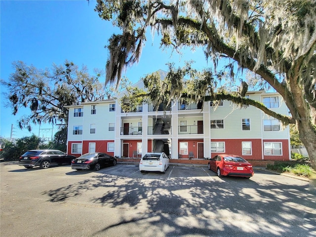 view of building exterior featuring uncovered parking