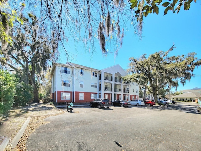 view of building exterior with uncovered parking