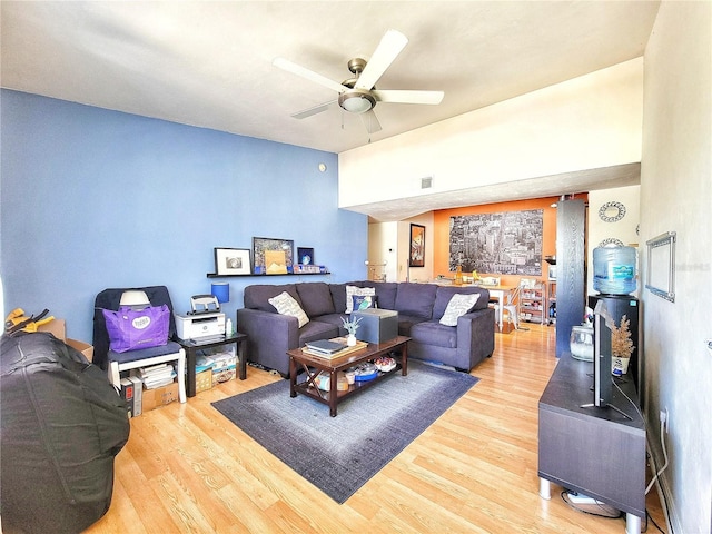 living area with visible vents, a ceiling fan, and light wood finished floors