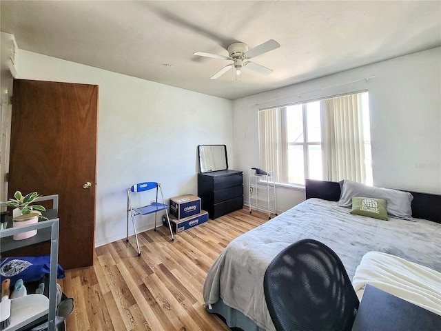 bedroom with light wood finished floors and a ceiling fan