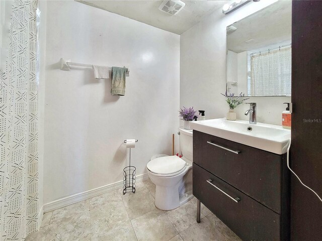 bathroom with visible vents, baseboards, toilet, and vanity