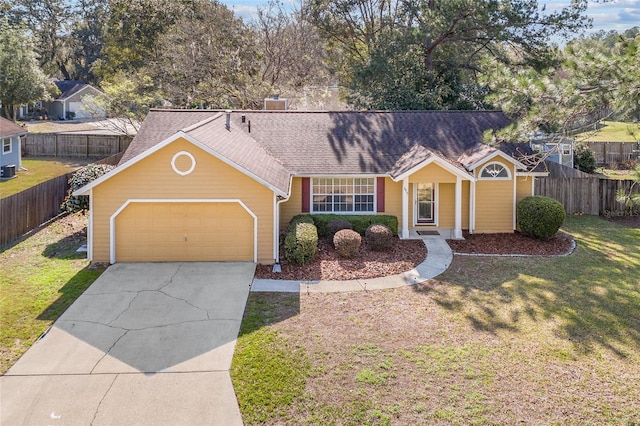 ranch-style home with driveway, roof with shingles, an attached garage, fence, and a front lawn