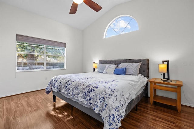 bedroom featuring lofted ceiling, ceiling fan, baseboards, and wood finished floors