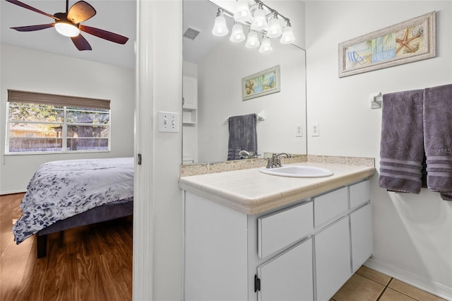 bathroom with visible vents, connected bathroom, ceiling fan, vanity, and tile patterned floors