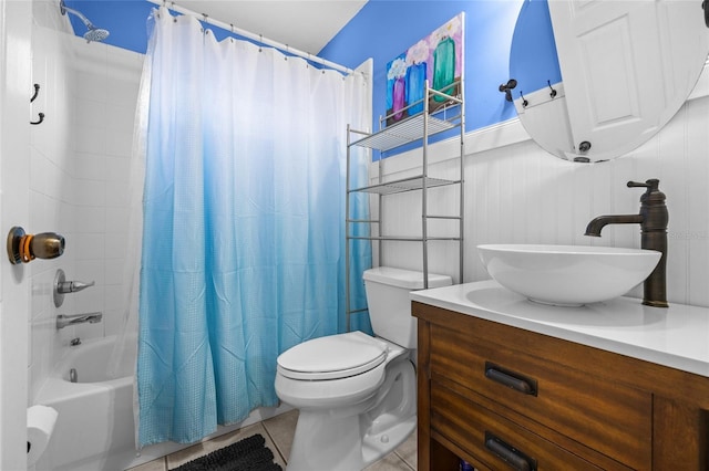 bathroom with shower / bath combo with shower curtain, vanity, toilet, and tile patterned floors